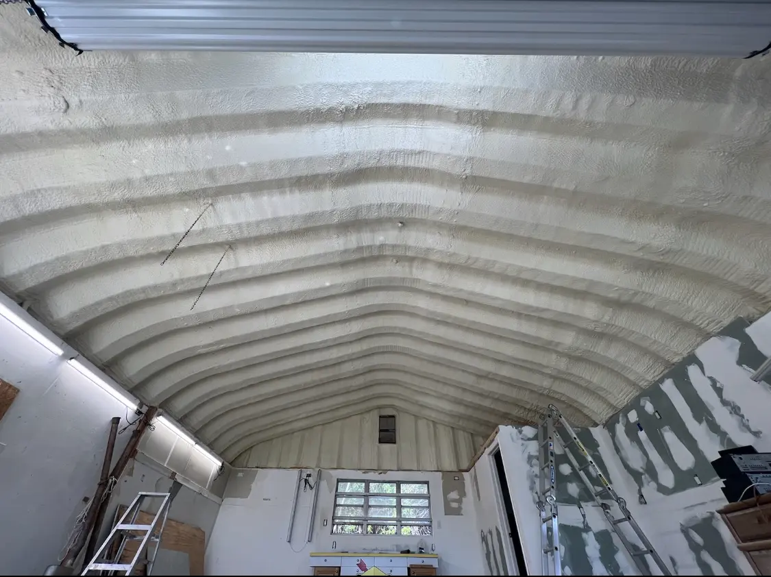 Spray polyurethane foam applied to the underside of a metal roof deck in Osprey
